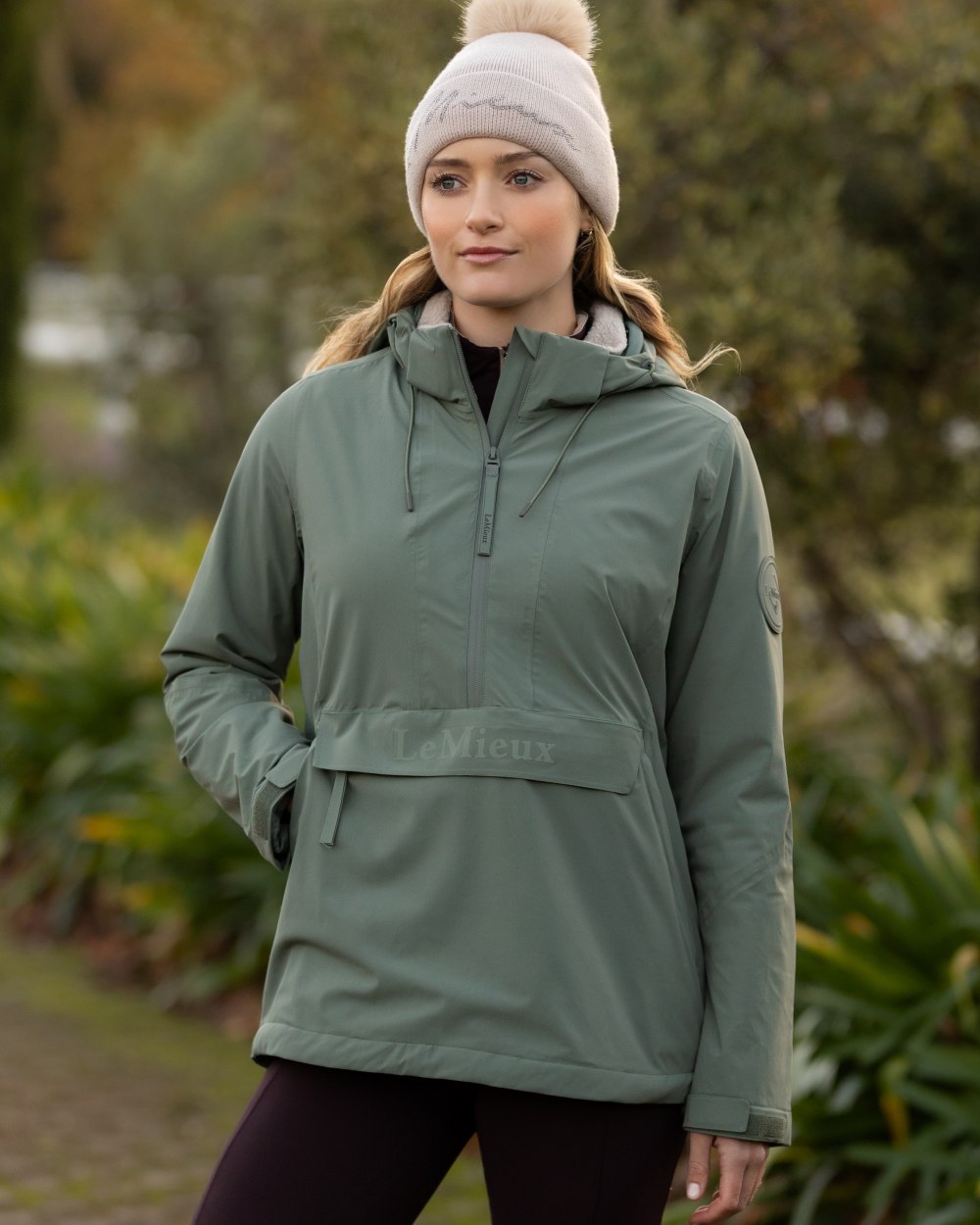 Rosemary coloured LeMieux Phoebe Half Zip Waterproof Anorak on tree background 