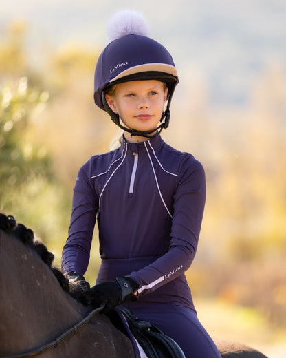 Juniper coloured LeMieux Pom Hat Silk on blurry background 