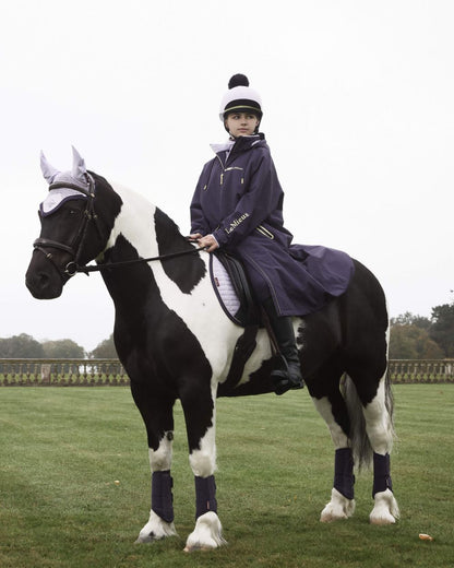 Lilac coloured LeMieux Pom Hat Silk on farm background 