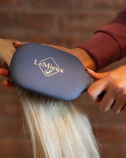 Powder Blue coloured LeMieux Tangle Tidy Brush on outdoor background 