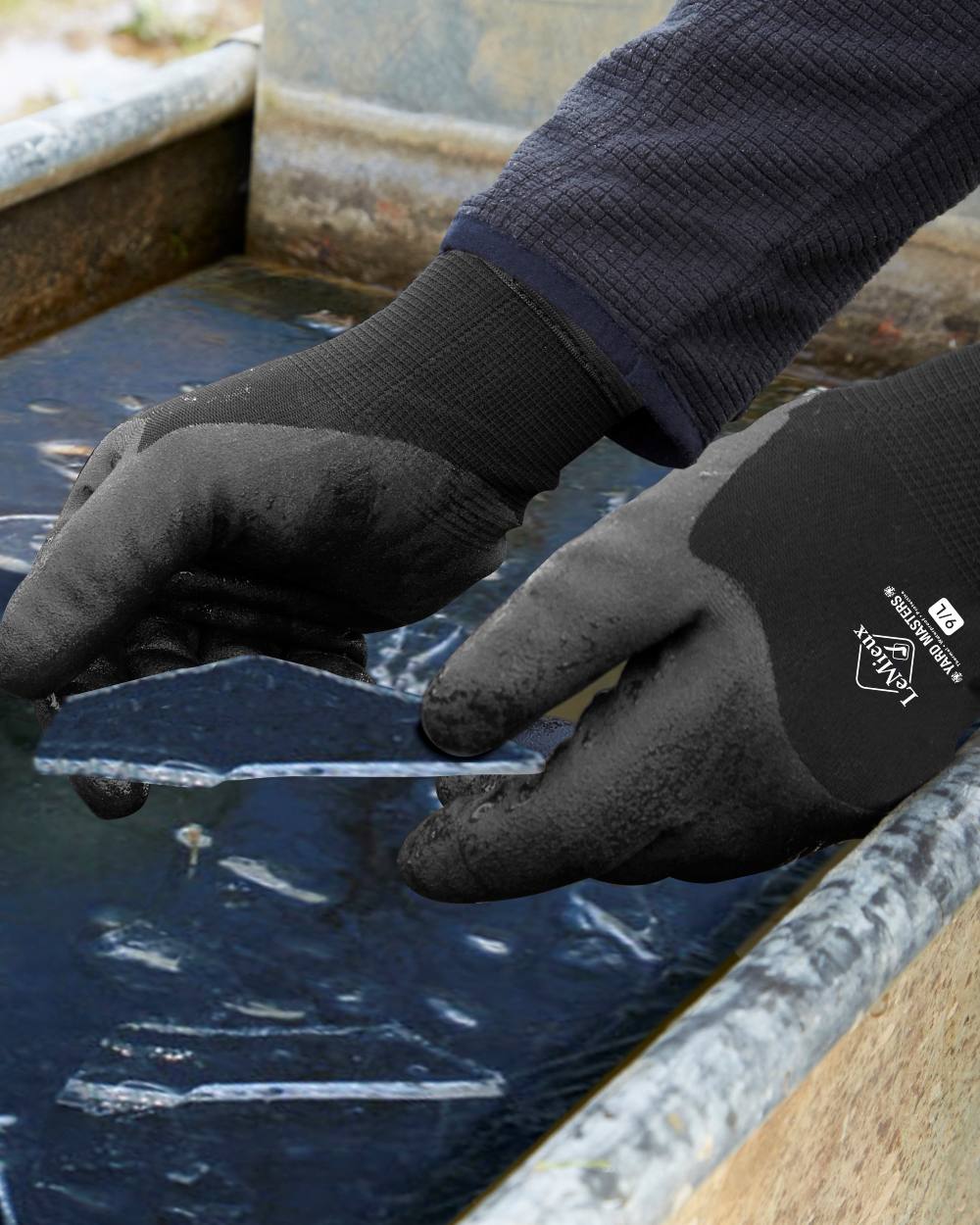 Black coloured LeMieux Thermal Work Gloves on outdoor background 
