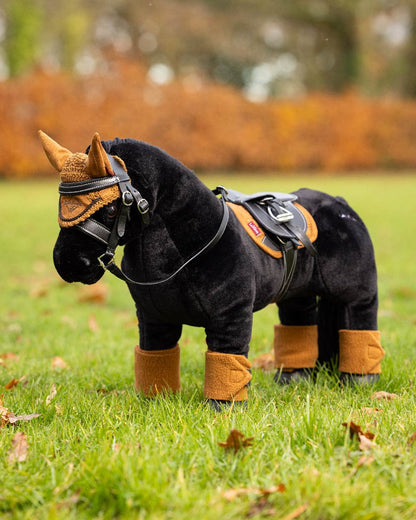 Ginger coloured LeMieux Toy Pony Bandages on blurry background 