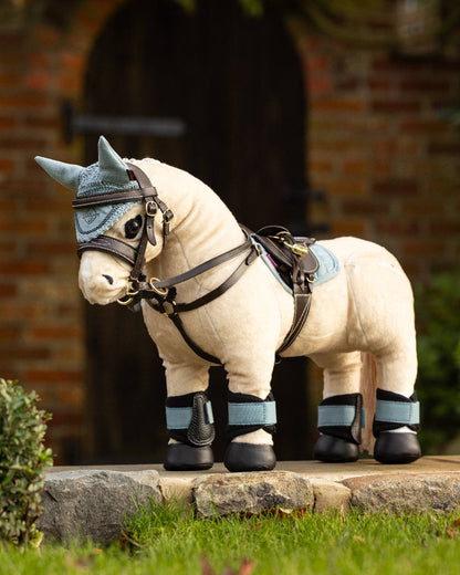 Glacier coloured LeMieux Toy Pony Fly Hood on yard background 