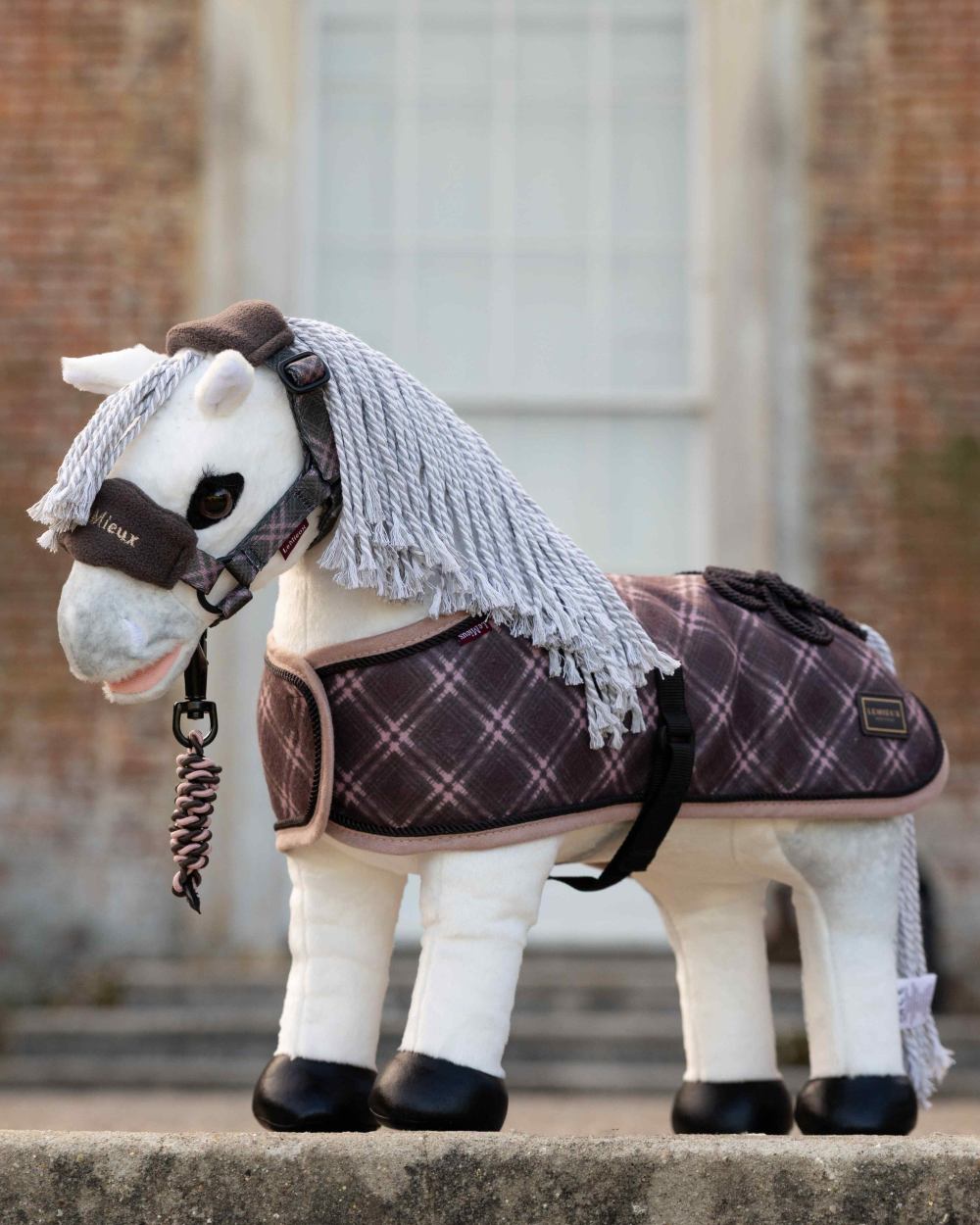 Cocoa coloured LeMieux Toy Pony Heritage Vogue Headcollar &amp; Leadrope on outdoor background 