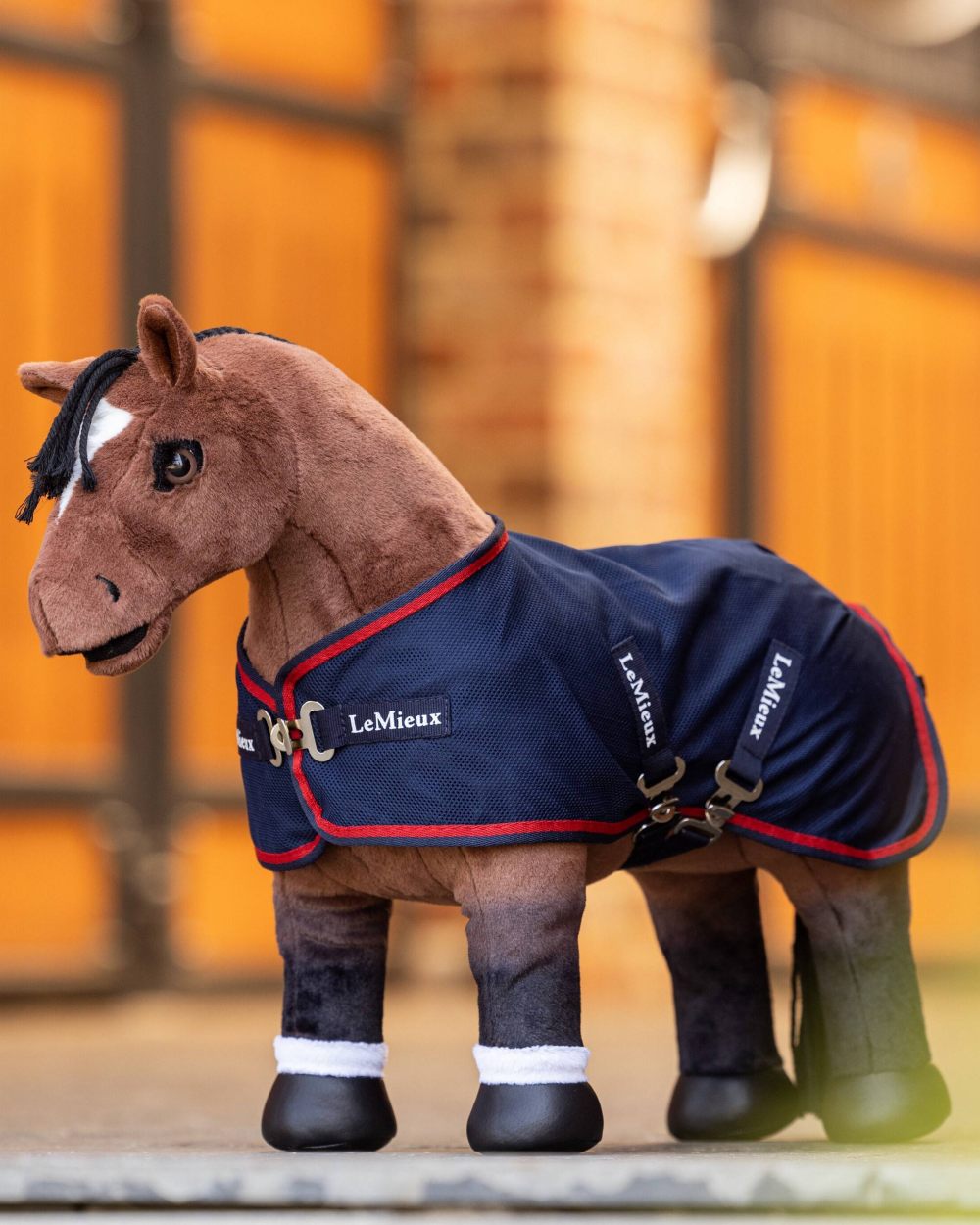 Navy coloured LeMieux Toy Pony Mesh Cooler on blurry background 