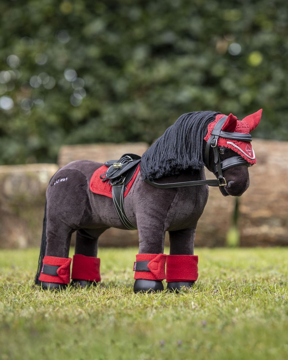 Chilli coloured LeMieux Toy Pony Pad on garden background 