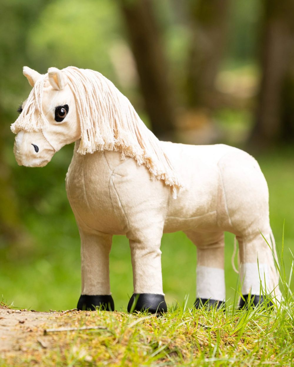 Popcorn coloured LeMieux Toy Pony Popcorn on grass background 