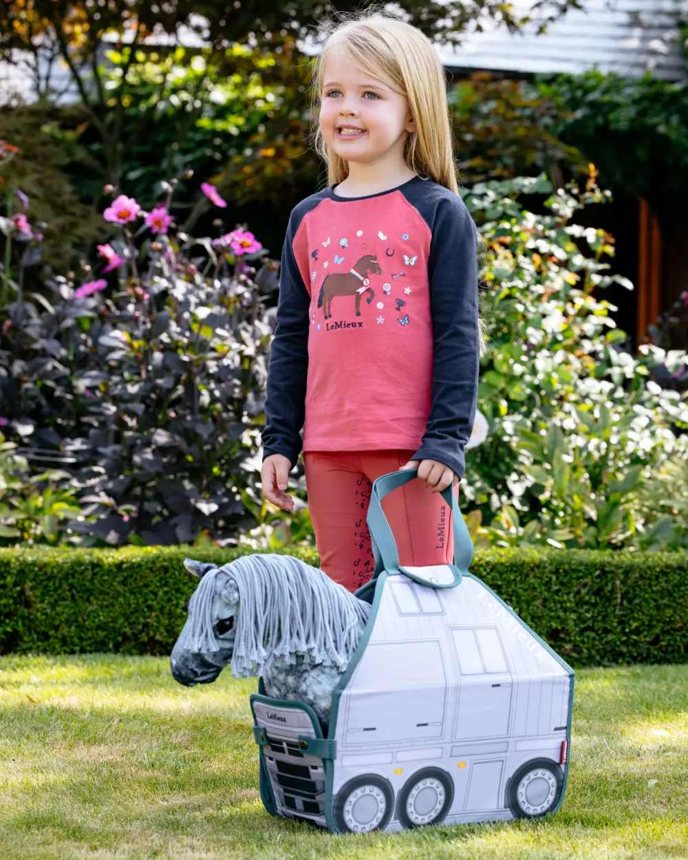 Multi coloured LeMieux Toy Pony Printed Carry Bag on garden background 