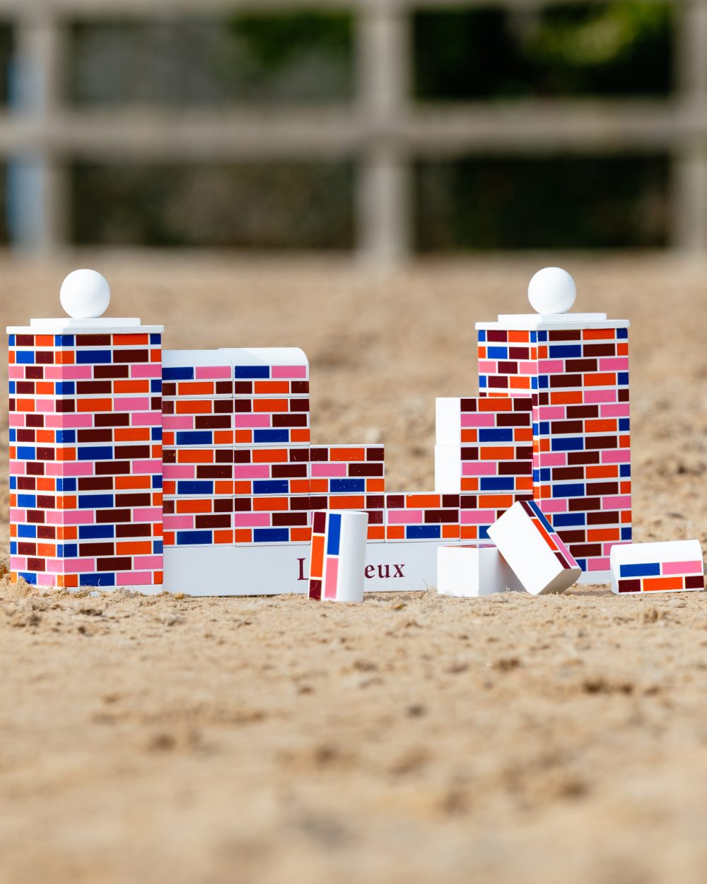 Multi coloured LeMieux Toy Pony Puissance Wall on sand background 