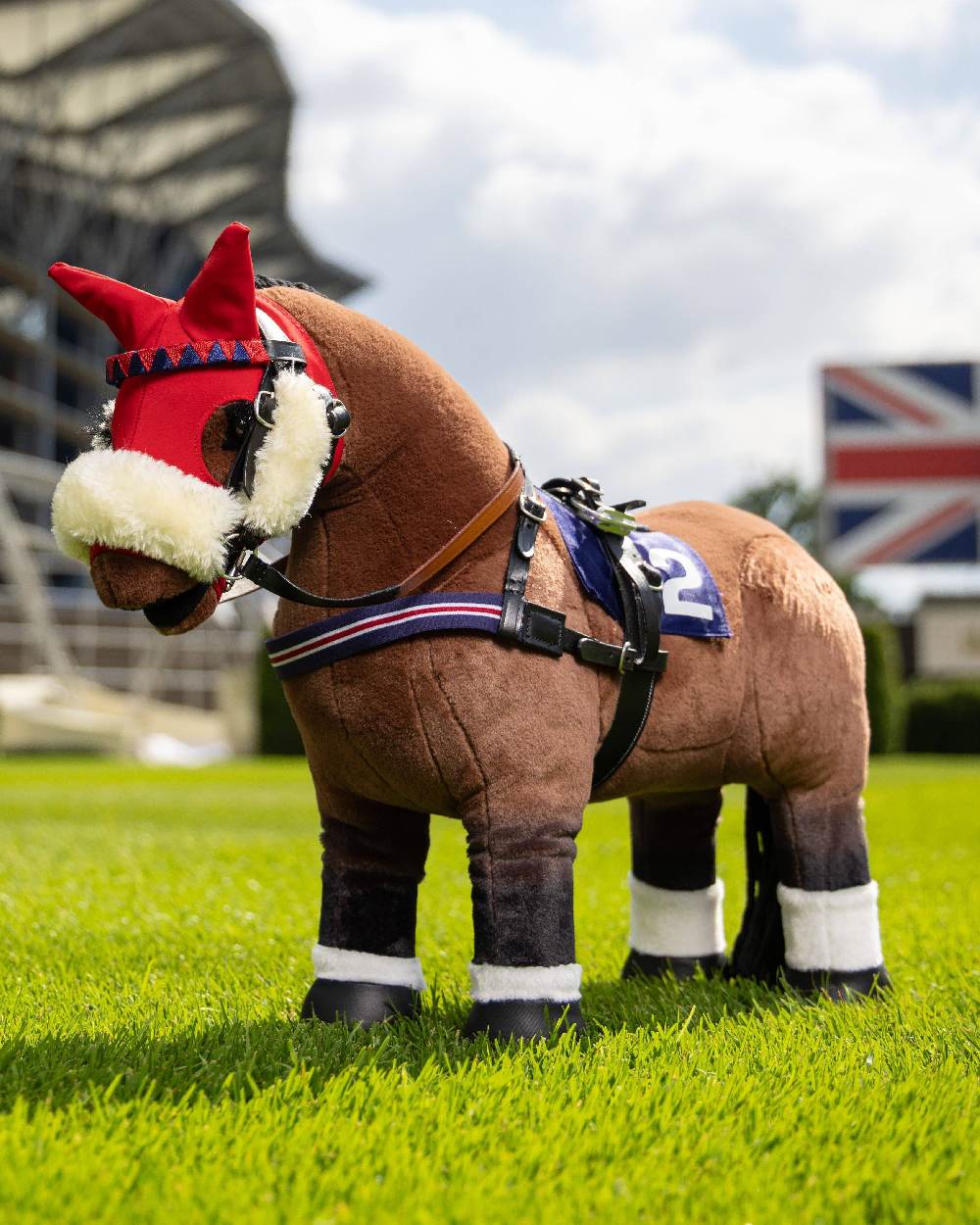 Black coloured LeMieux Toy Pony Racing Bridle Set on grass background 