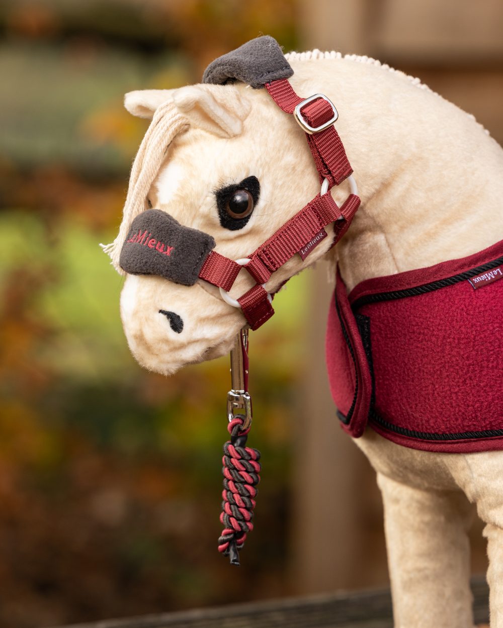 Ember coloured LeMieux Toy Pony Vogue Headcollar on blurry background 