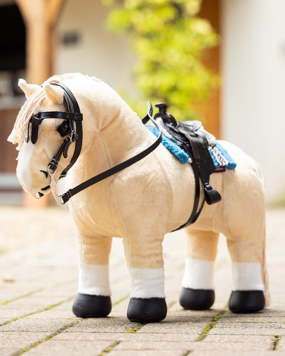 Black coloured LeMieux Toy Pony Western Bridle on blurry background 