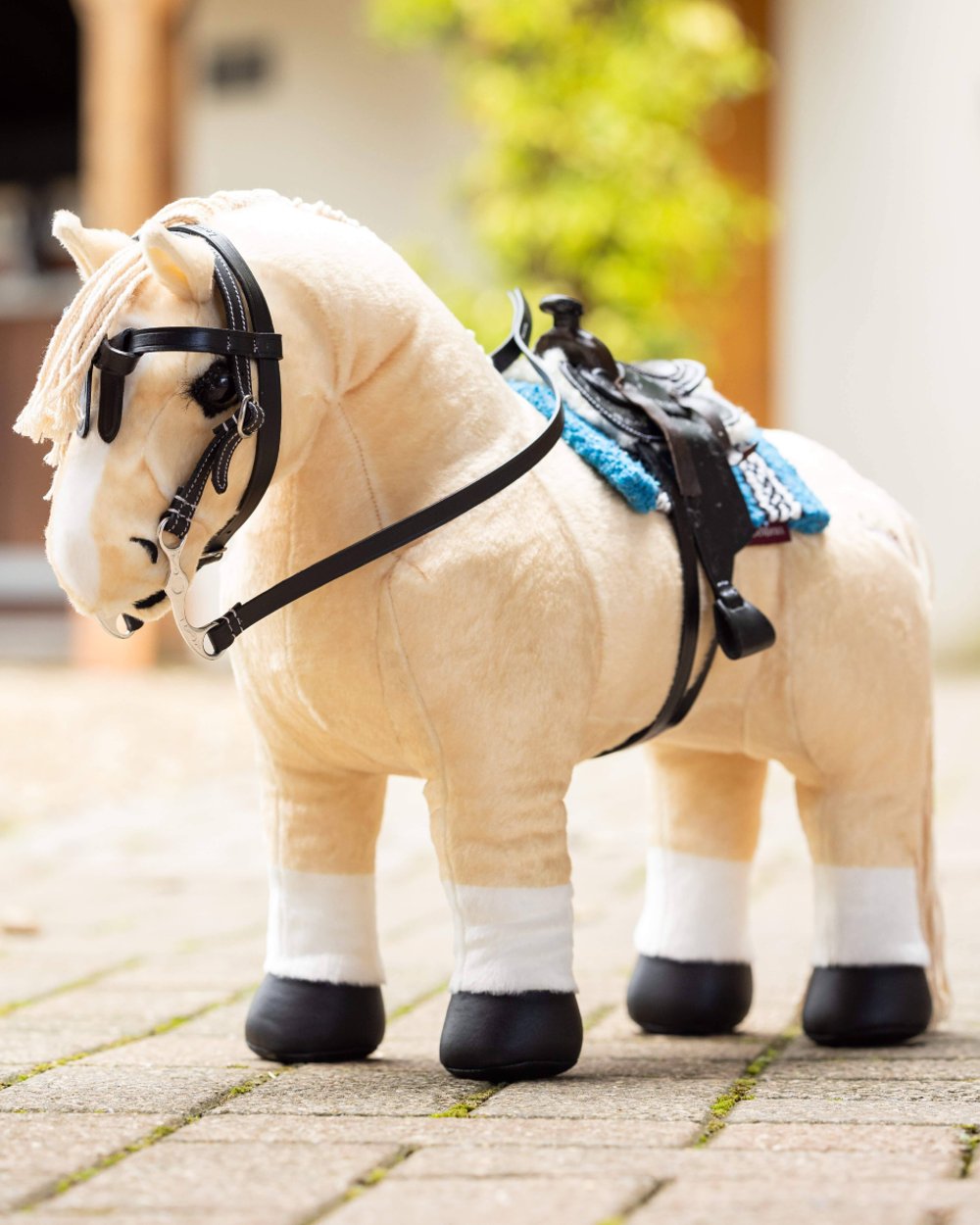 Black coloured LeMieux Toy Pony Western Saddle on blurry background 
