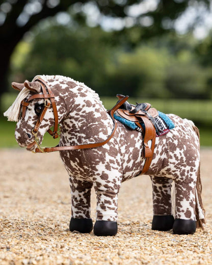 Tan coloured LeMieux Toy Pony Western Saddle on blurry background 