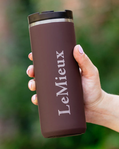 Damson Coloured LeMieux Travel Cup On A Blurry Background 