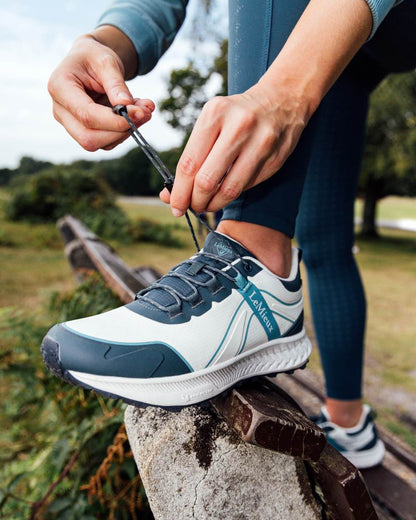 Petrol coloured LeMieux Trax Sports Waterproof Trainers on blurry background 