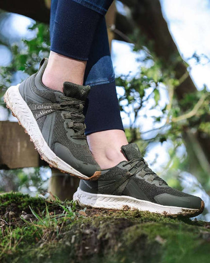 Khaki coloured LeMieux Trax Waterproof Trainers on blurry background 