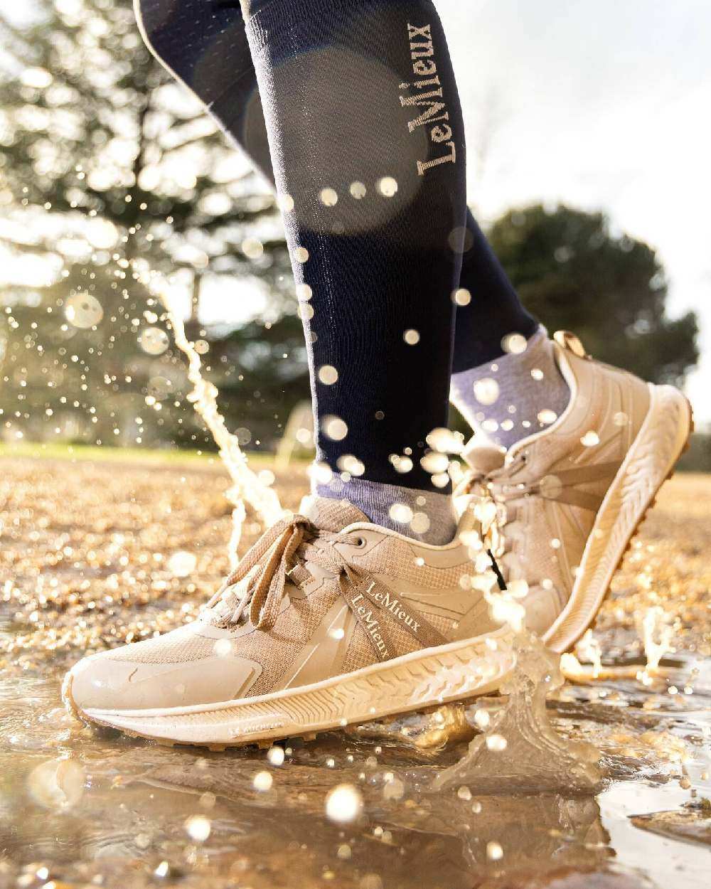 Stone coloured LeMieux Trax Waterproof Trainers on blurry background 