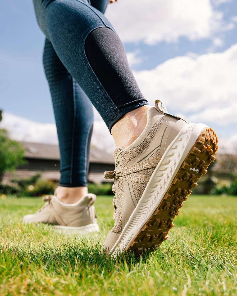 Stone coloured LeMieux Trax Waterproof Trainers on sky background 