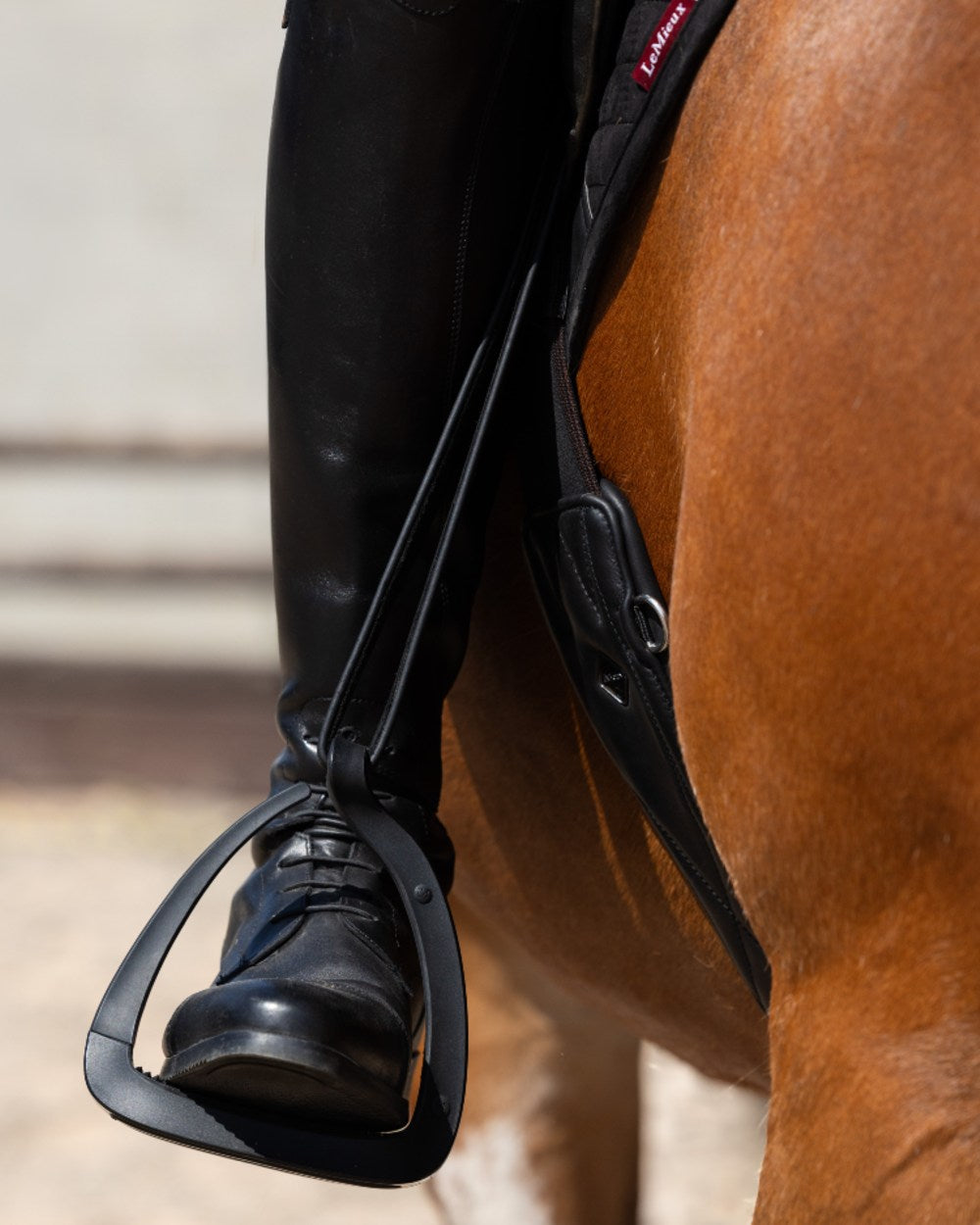Black coloured LeMieux VectorFlex Stirrup Arm on outdoor background 