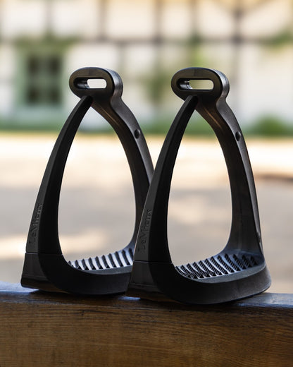 Black coloured LeMieux VectorFlex Stirrup Arm on outdoor background 