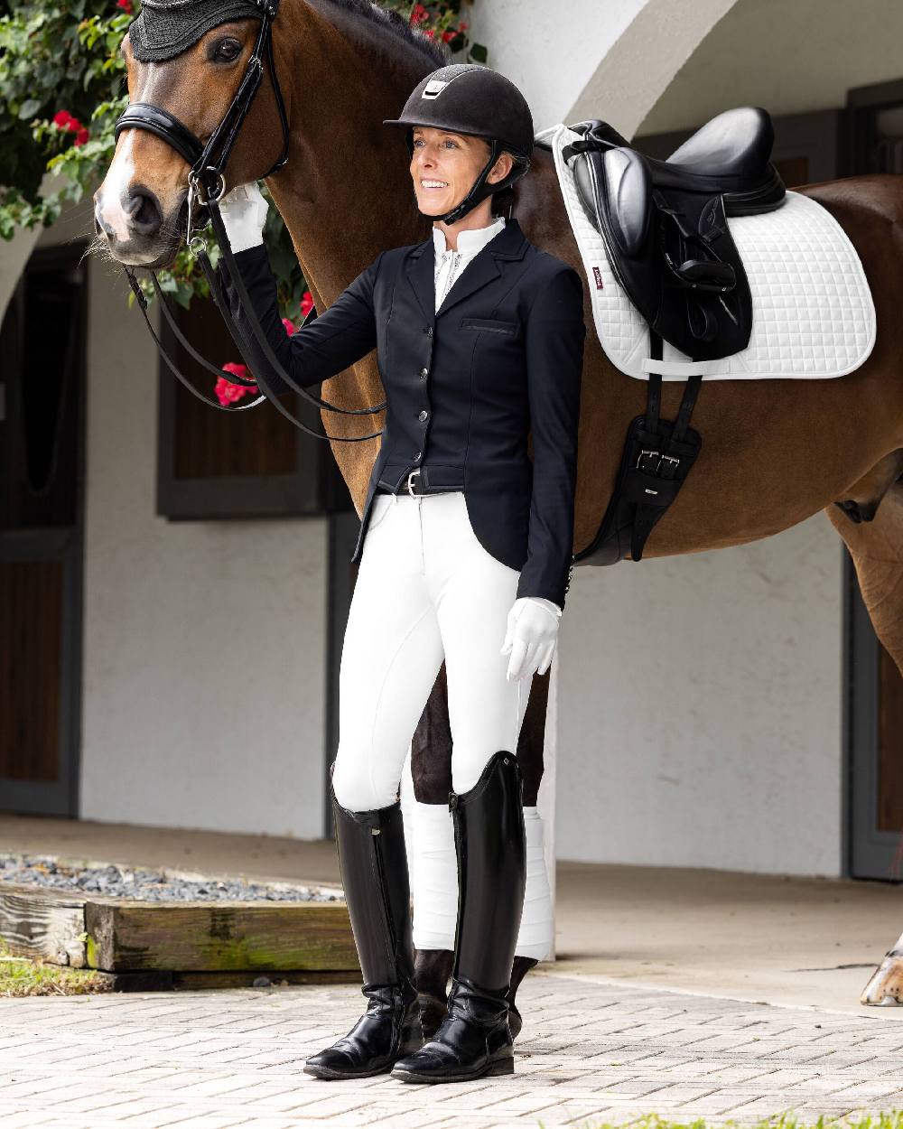 White coloured LeMieux Victoria Suede Seat Breeches with house in background 