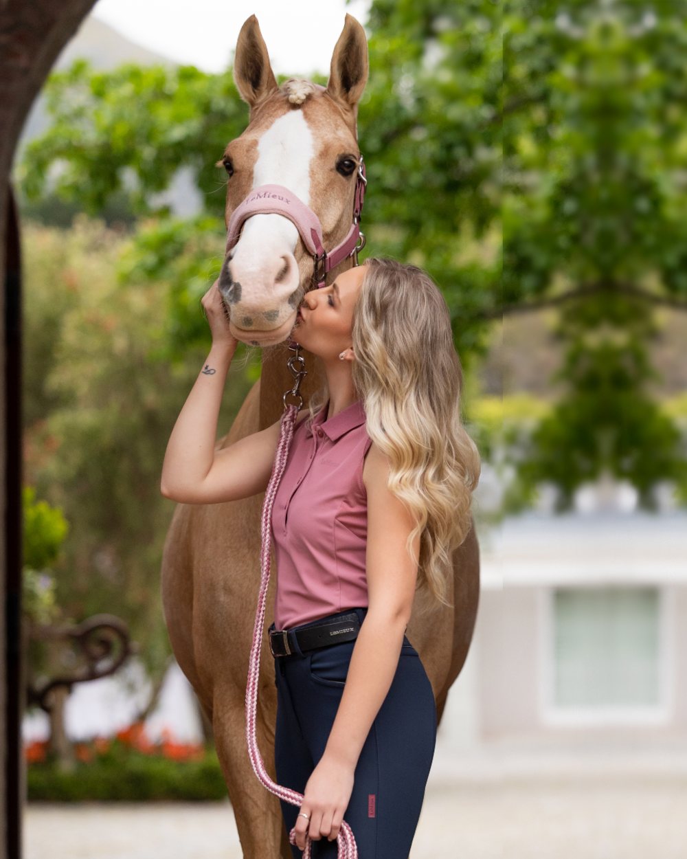 Blossom coloured LeMieux Vogue Headcollar &amp; Leadrope on backyard background 