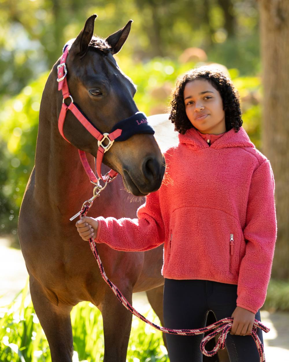 Cranberry coloured LeMieux Vogue Headcollar &amp; Leadrope on outdoor background 