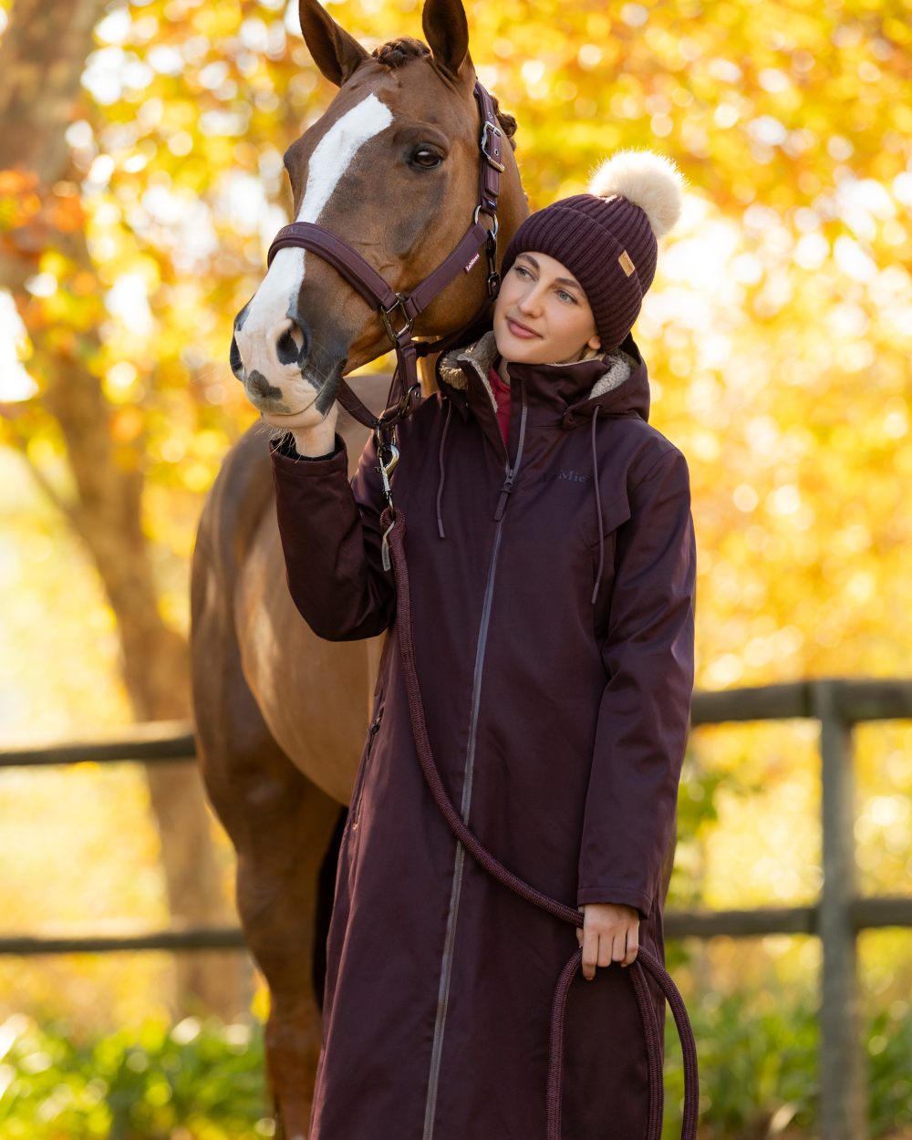 Damson coloured LeMieux Womens All Elements Robe Coat on outdoor background 