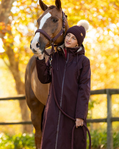Damson coloured LeMieux Womens All Elements Robe Coat on outdoor background 
