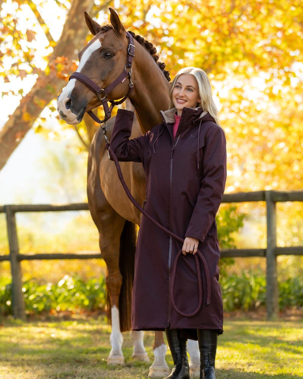 Damson coloured LeMieux Womens All Elements Robe Coat on outdoor background 