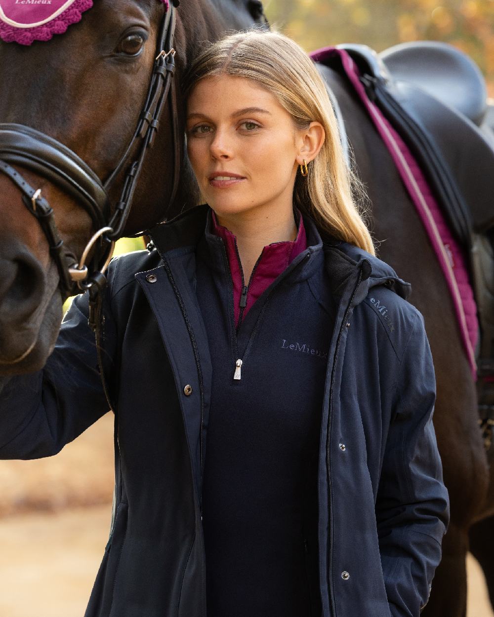 Navy Coloured LeMieux Womens Erin Waterproof Padded Coat on Outdoor with Horse Background 