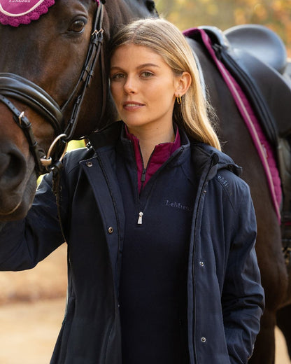 Navy Coloured LeMieux Womens Erin Waterproof Padded Coat on Outdoor with Horse Background 