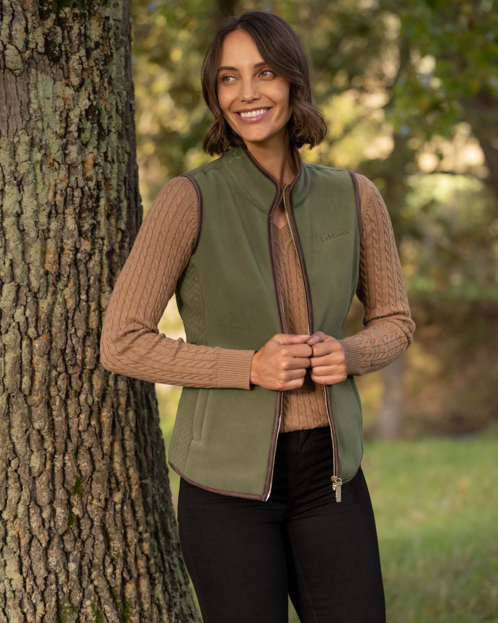 Willow Green coloured LeMieux Womens Frankie Fleece Gilet on forest background 
