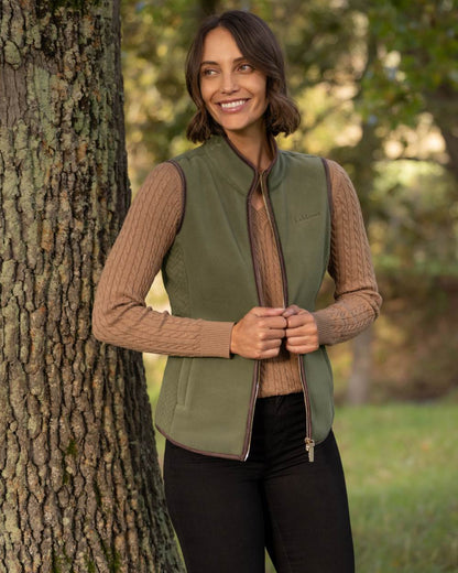 Willow Green coloured LeMieux Womens Frankie Fleece Gilet on forest background 