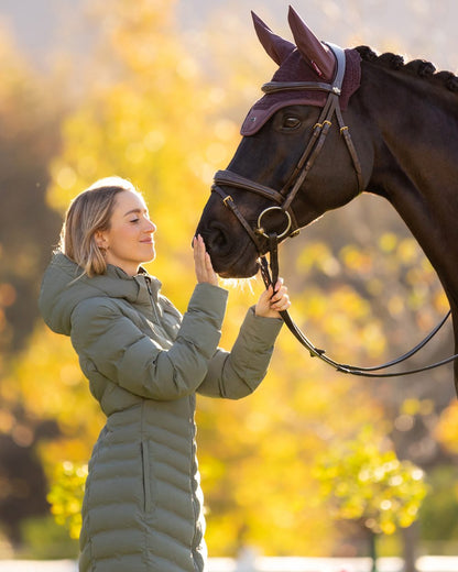 Rosemary coloured LeMieux Womens Hayley Water Resistant Longline Puffer Coat on tree background 