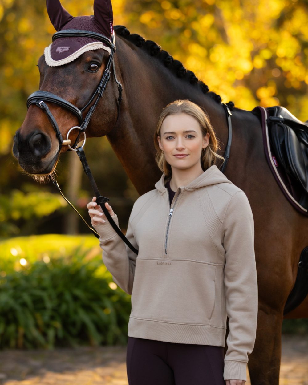 Almond coloured LeMieux Womens Henrietta Half Zip Hoodie on tree background 