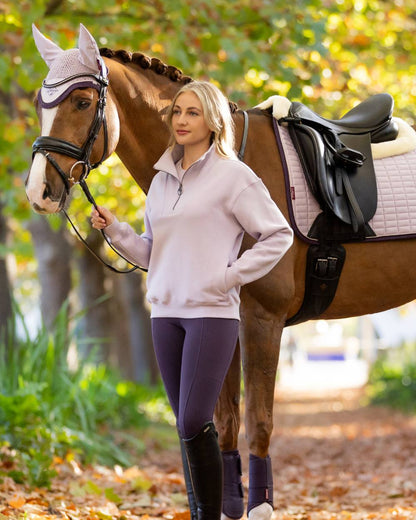 Lilac coloured LeMieux Womens Keira Quarter Neck Sweatshirt on forest background 