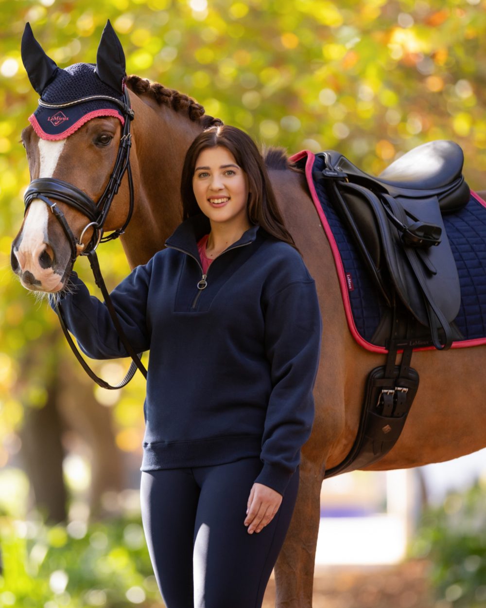 Navy coloured LeMieux Womens Keira Quarter Neck Sweatshirt on tree background 