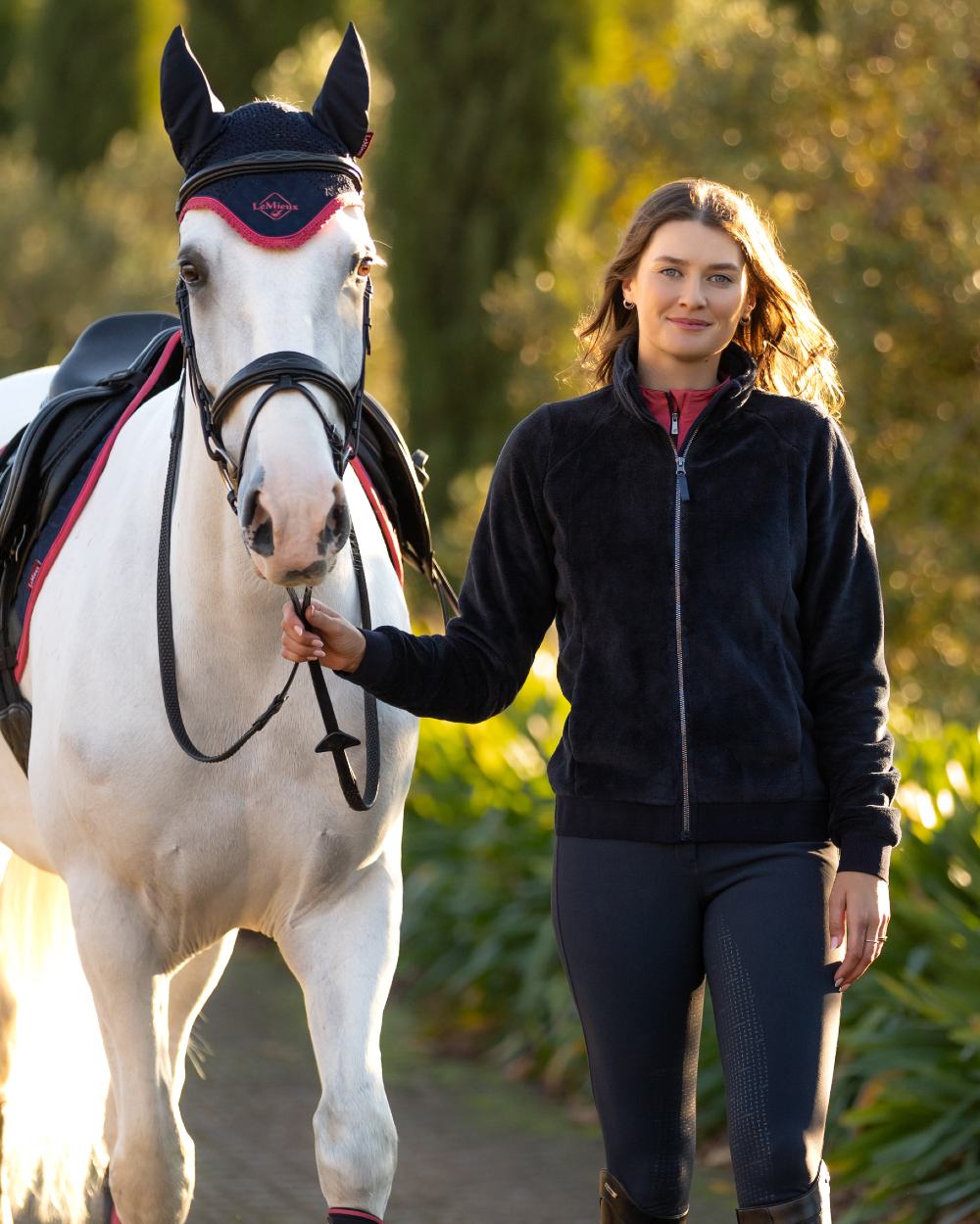 Navy coloured LeMieux Womens Liberty Fleece Zip Through Jacket on tree background 