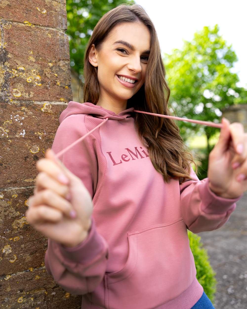 Peony coloured LeMieux Womens Nadine Hoodie on wall background 