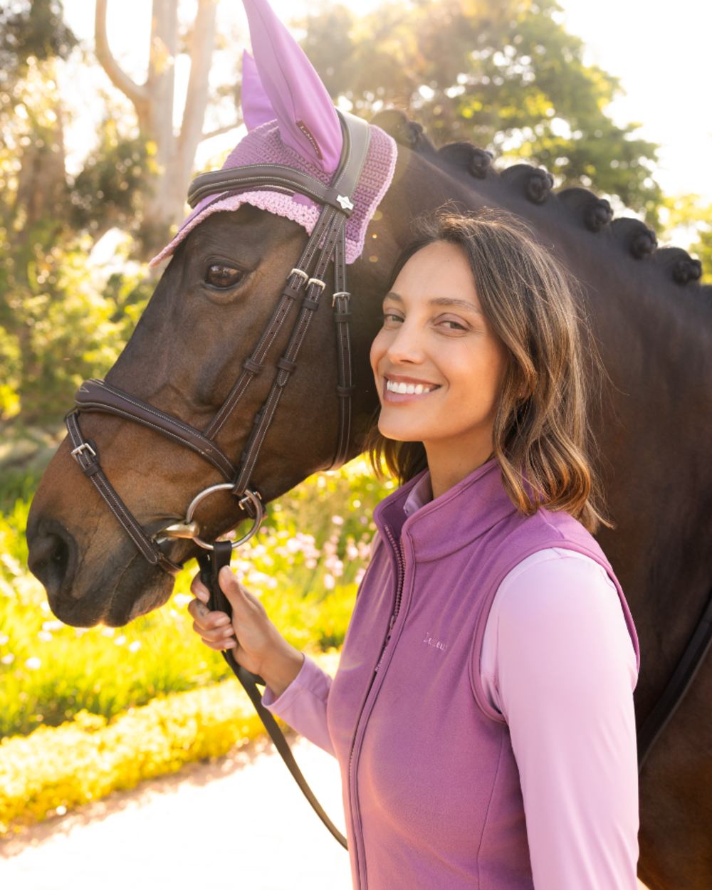 Mallow coloured LeMieux Womens Roberta Fleece Gilet on garden background 