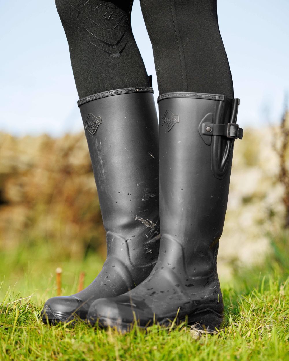 Black Coloured LeMieux Womens Ultra Stride Wellington Boots on grass background 