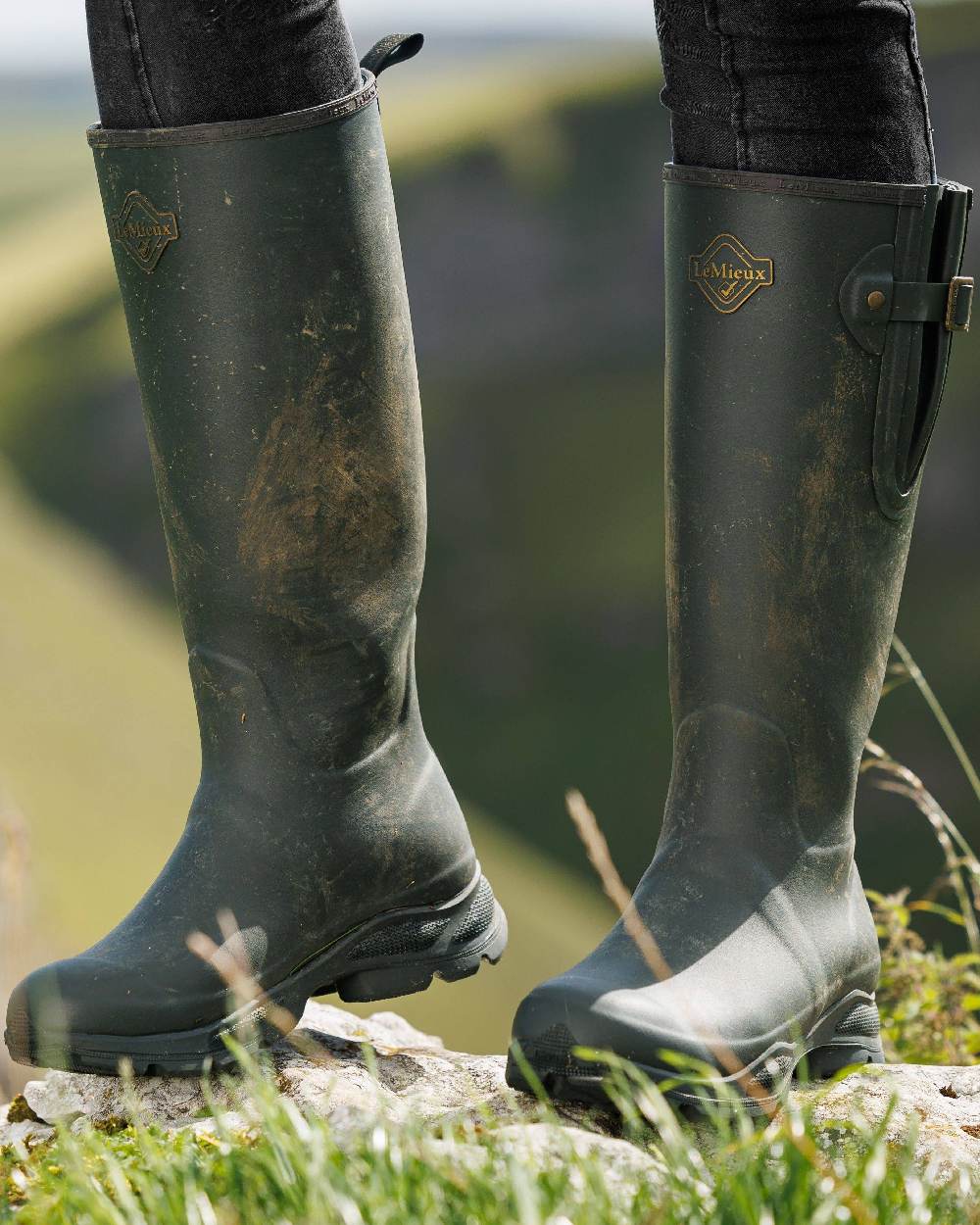 Oak Coloured LeMieux Womens Ultra Stride Wellington Boots on blurry background 