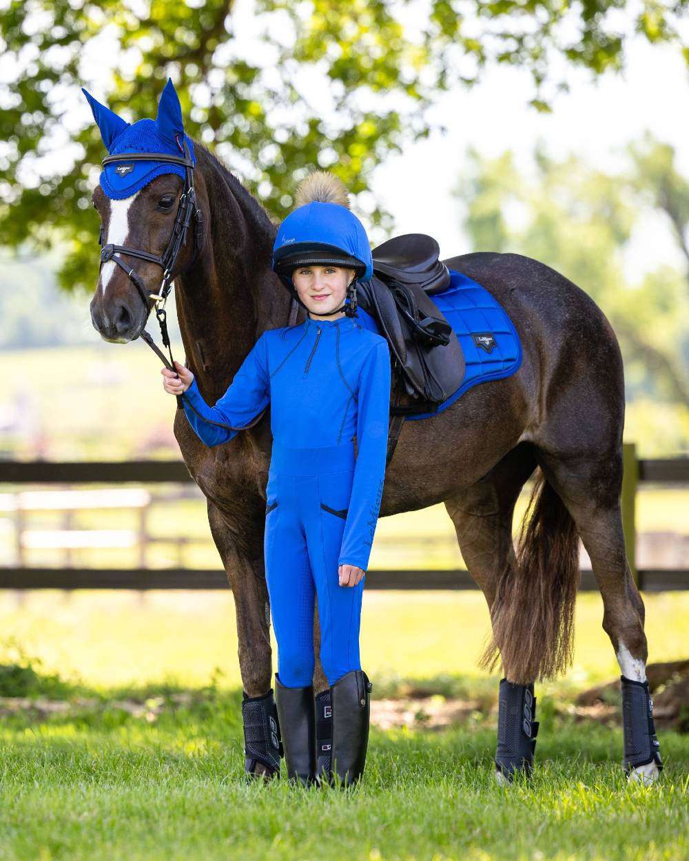 Benetton coloured LeMieux Young Rider Base Layer on yard background 