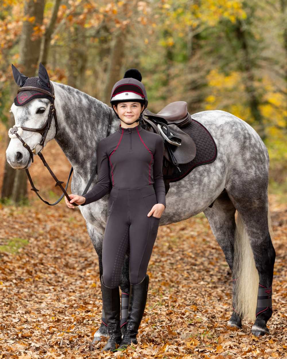 Cinder coloured LeMieux Young Rider Base Layer on yard background 