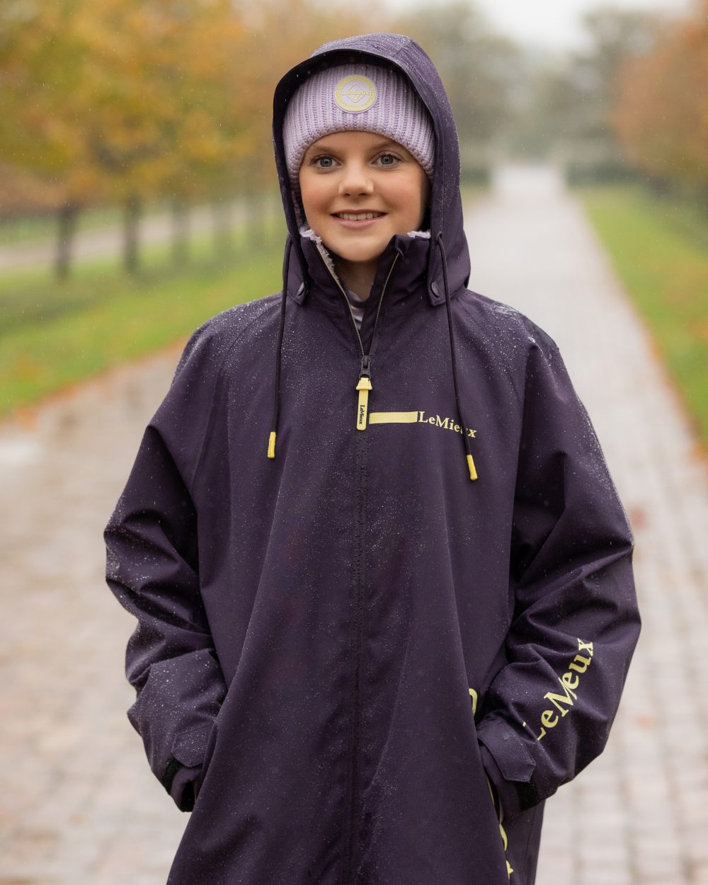 Juniper coloured LeMieux Young Rider HydroShield Robe Long Coat on tree background 