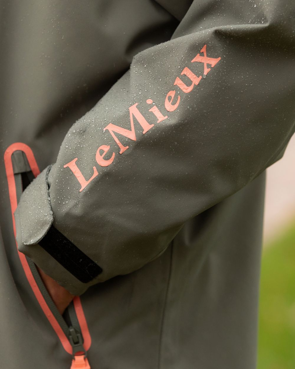 Rosemary coloured LeMieux Young Rider HydroShield Robe Long Coat on garden background 