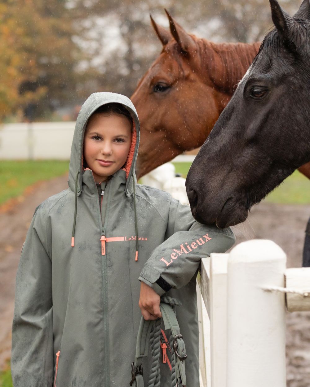 Rosemary coloured LeMieux Young Rider HydroShield Robe Long Coat on garden background 