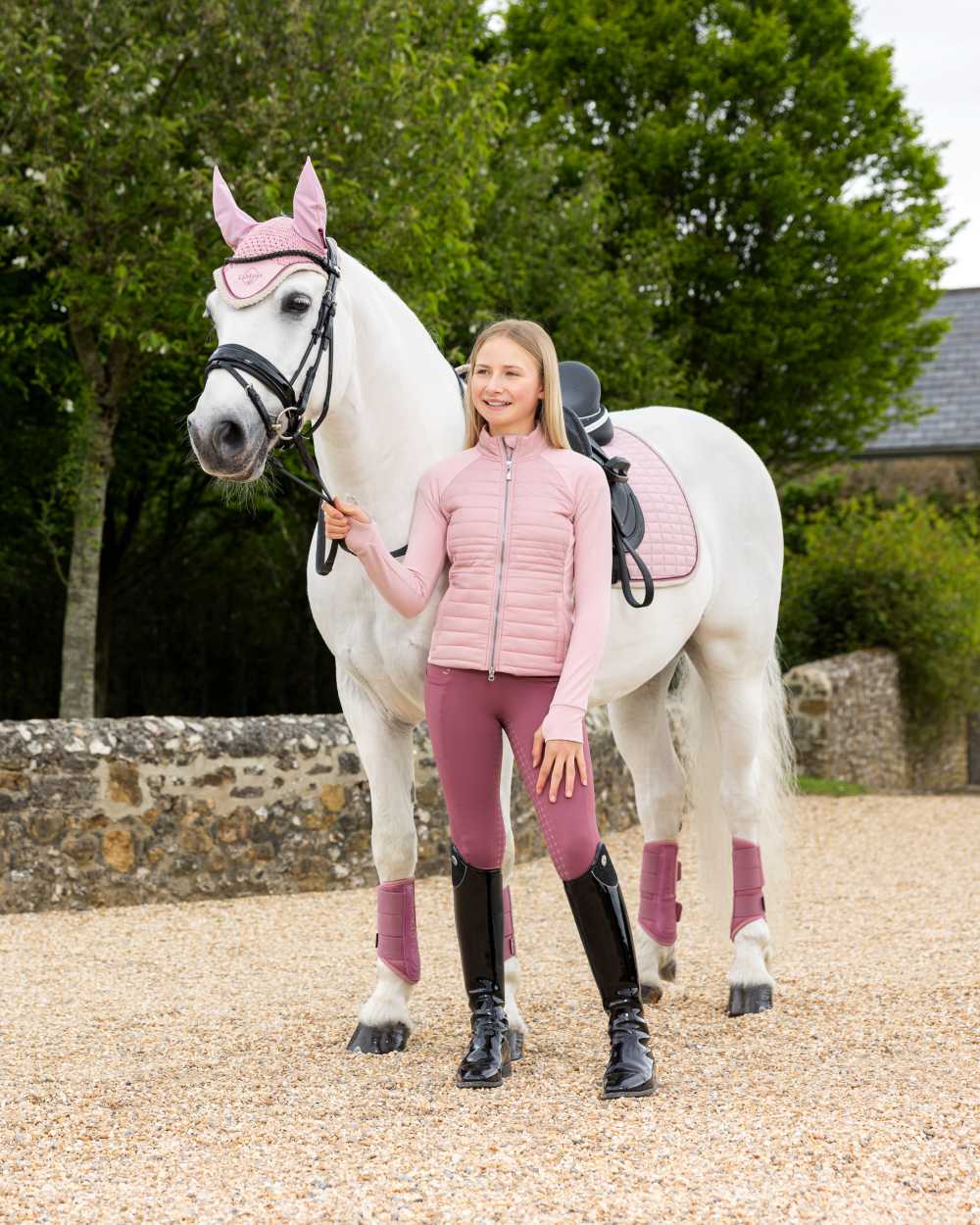 Blossom coloured LeMieux Young Rider Josephine Jacket on street background 